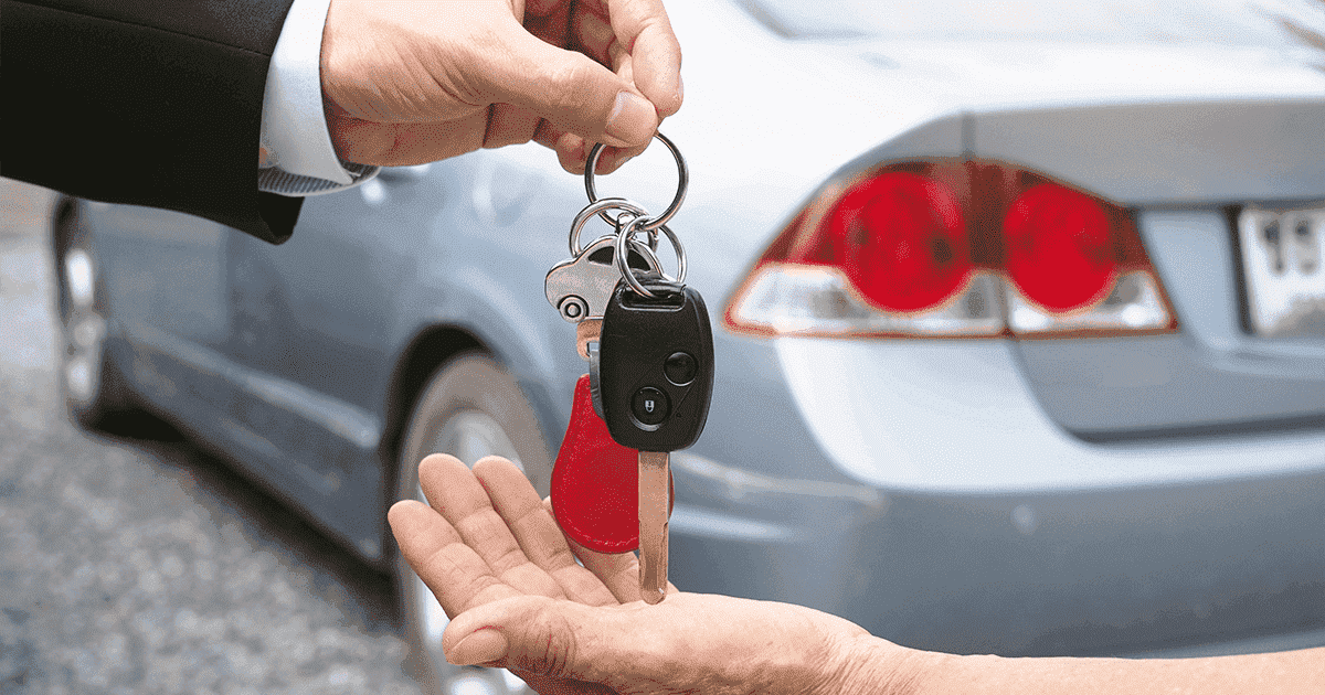 Imagem de uma pessoa entregando a chave do carro para outra pessoa.